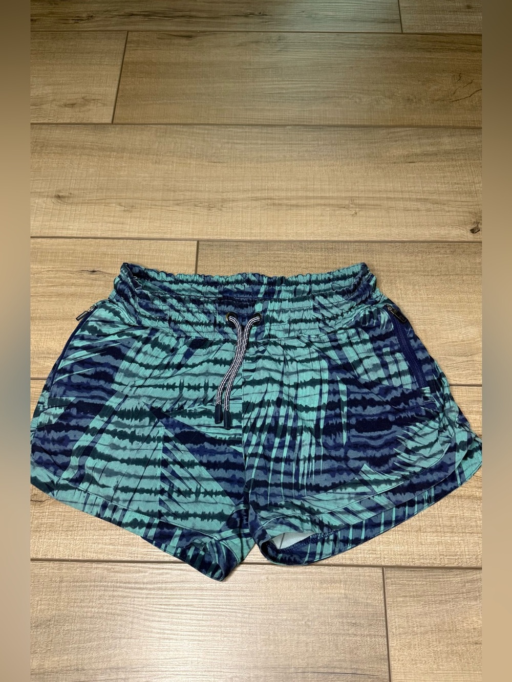 Athleta Girl Running Shorts L 12 Blue Tropical Print Zip Pockets Athletic